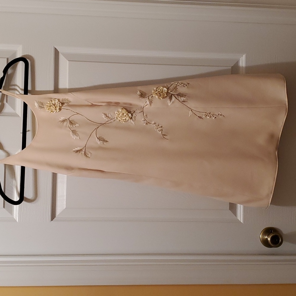 Boutique dress in cream with beautiful appliques  and crisscross straps in back
